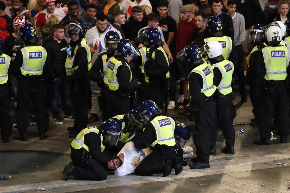 Police detain an England fan outside Wembley stadium during the Euro final against Italy in London July 11, 2021. — Reuters pic