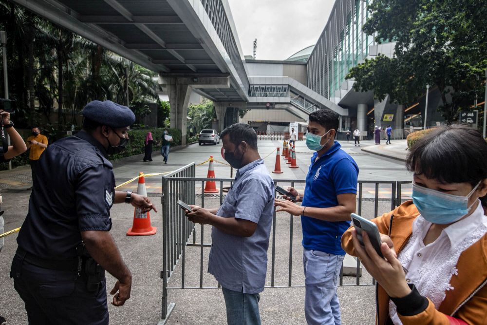 Foreign workers are pictured at the KLCC vaccination centre to receive their Covid-19 jab July 29, 2021. u00e2u20acu201d Picture by Firdaus Latif