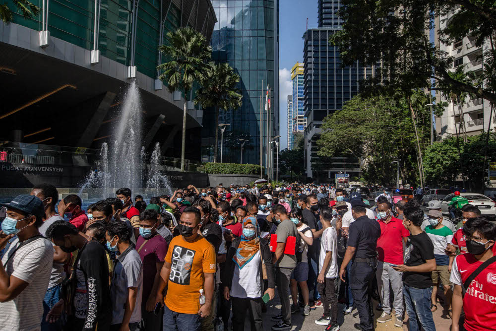 Foreign workers are seen at the KLCC vaccination centre to receive their Covid-19 jab July 28, 2021. u00e2u20acu201d Picture by Firdaus Latif