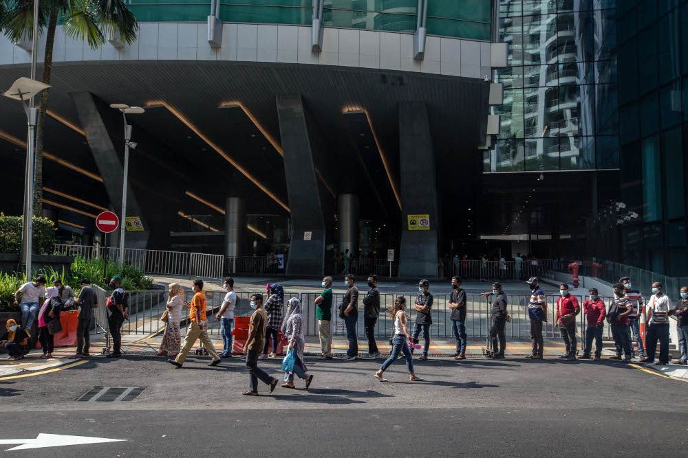 Foreign workers are seen at the KLCC vaccination centre to receive their Covid-19 jab July 28, 2021. u00e2u20acu201d Picture by Firdaus Latif