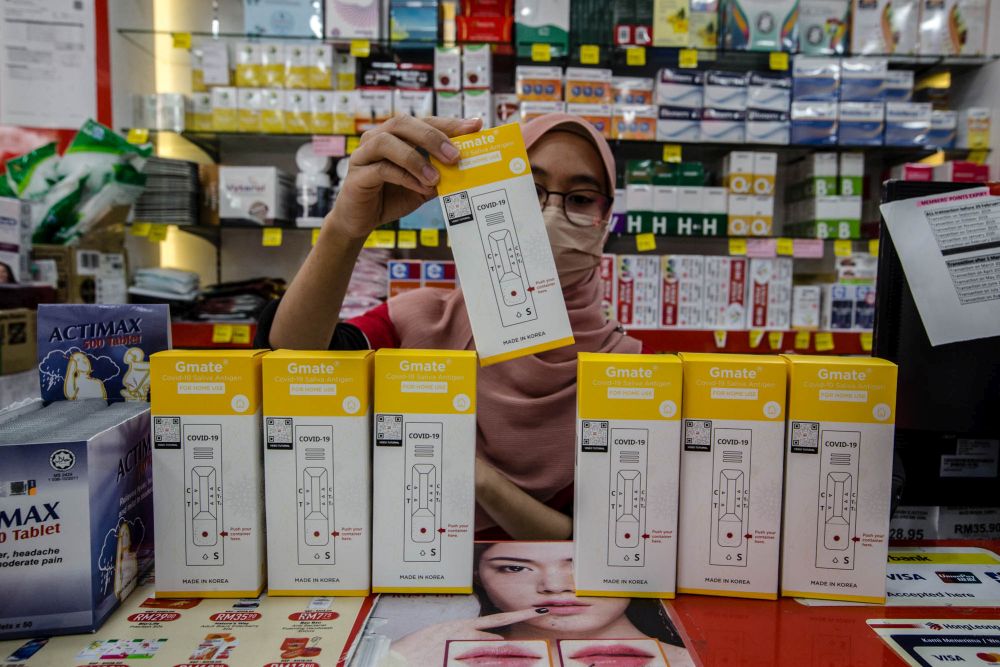 A worker is seen arranging the Gmate Covid-19 rapid antigen self-test kits at a Big Pharmacy outlet in Kuala Lumpur July 28, 2021. u00e2u20acu201d Picture by Firdaus Latif