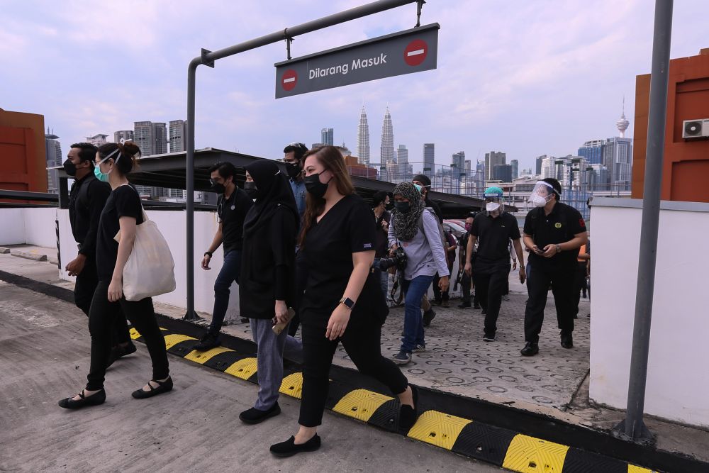 Contract doctors dressed in black stage a walkout at the Kuala Lumpur Hospital July 26, 2021. u00e2u20acu201d Picture by Ahmad Zamzahuri