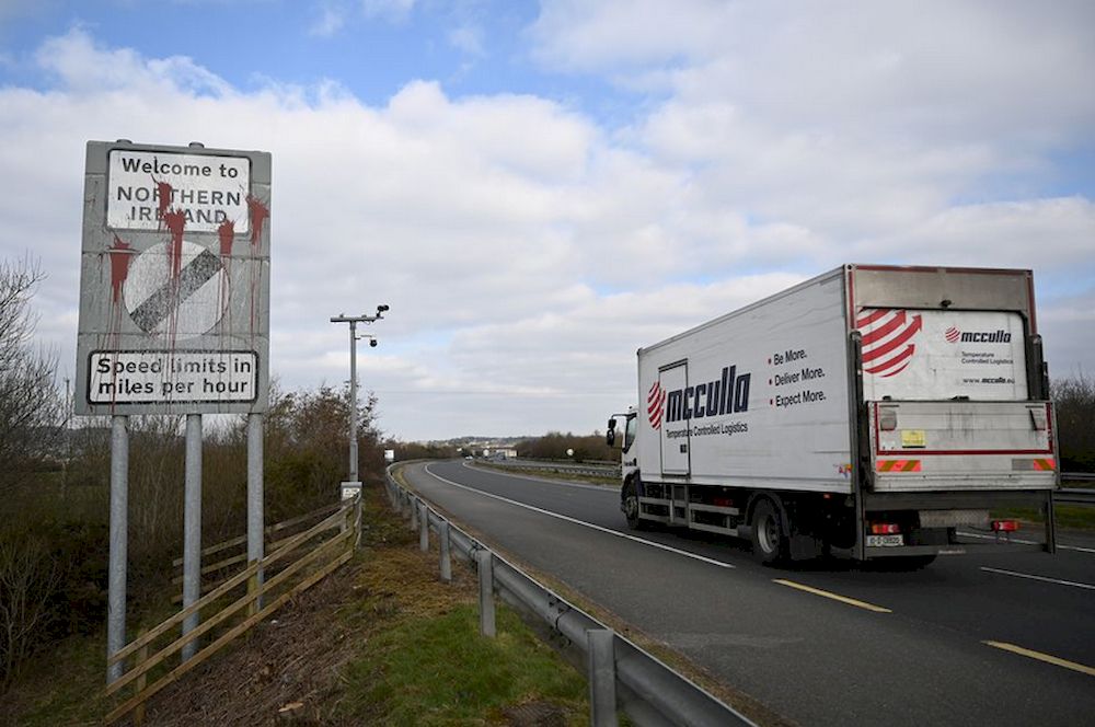 A truck drives past a defaced u00e2u20acu02dcWelcome to Northern Irelandu00e2u20acu2122 sign on the Ireland and N. Ireland border reminding motorists that the speed limits will change from kilometres per hour to miles per hour on the border in Carrickcarnan, Ireland, March 6, 20