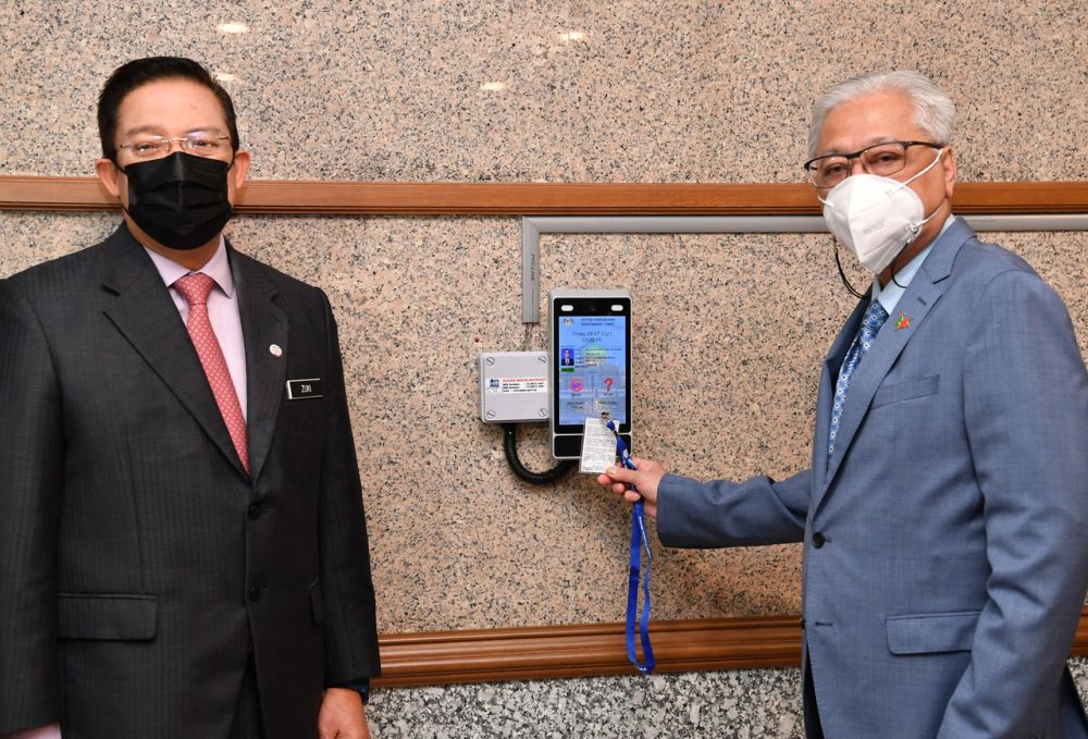 Datuk Seri Ismail Sabri Yaakob (right) clocks in on his first day at work as deputy prime minister in Putrajaya July 9, 2021. u00e2u20acu201d Bernama pic