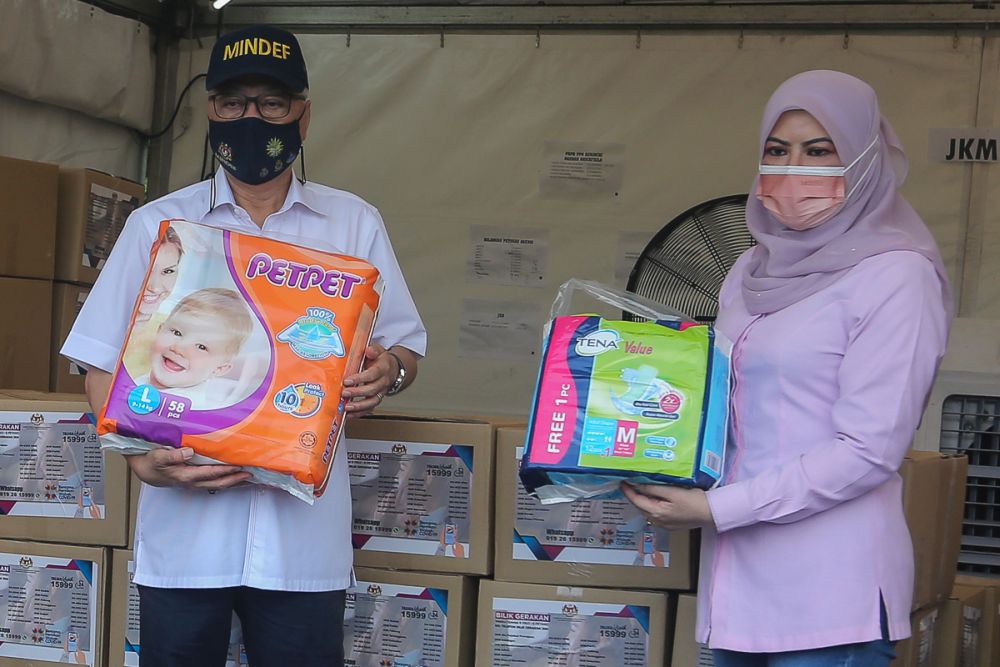 Deputy Prime Minister Datuk Seri Ismail Sabri Yaakob and Woman, Family and Community Development Minister Datuk Seri Rina Mohd Harun during a visit to the Kerinchi PPR in Kuala Lumpur July 11, 2021. u00e2u20acu201d Picture by Yusof Mat Isa