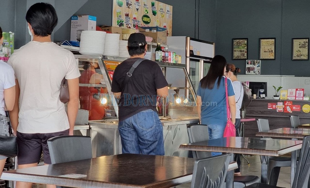 Customers at Patrila’s eatery opting for takeaways rather than dining in. — Picture by Chimon Upon via Borneo Post Online