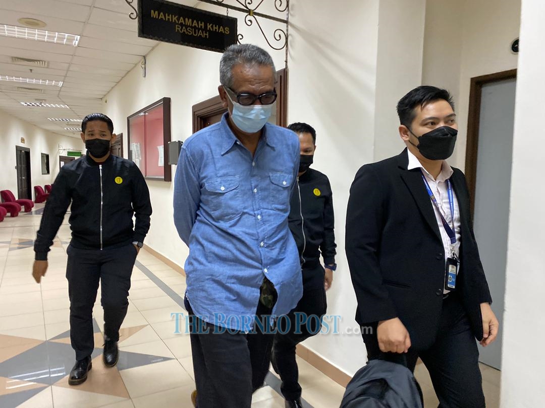 Tamisan Tumen (left) leaves the courtroom after sentencing. Seen behind him are Malaysian Anti-Corruption Commission officers. u00e2u20acu2022 Borneo Post pic