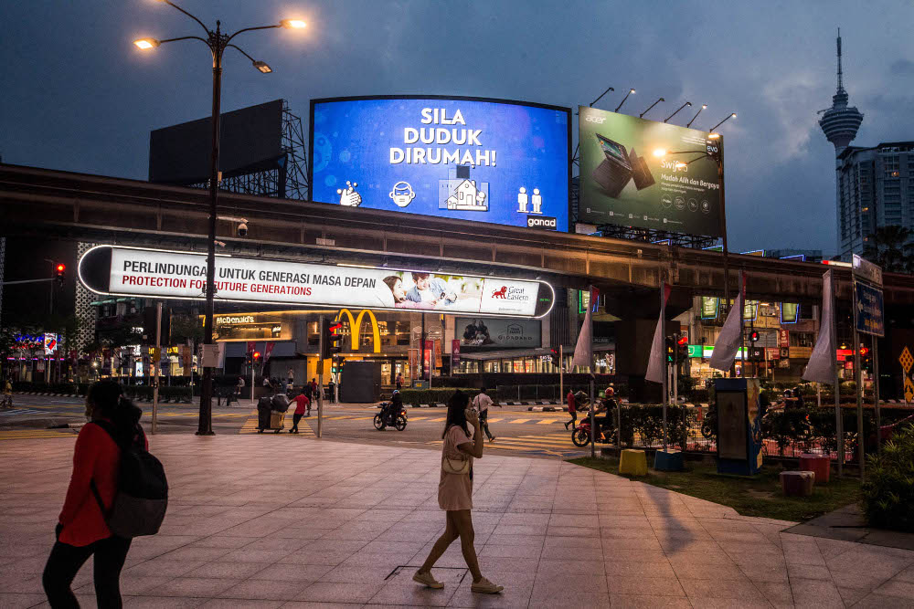 Pedestrians walk on the street in Kuala Lumpur July 9, 2021. u00e2u20acu201d Picture by Firdaus Latif
