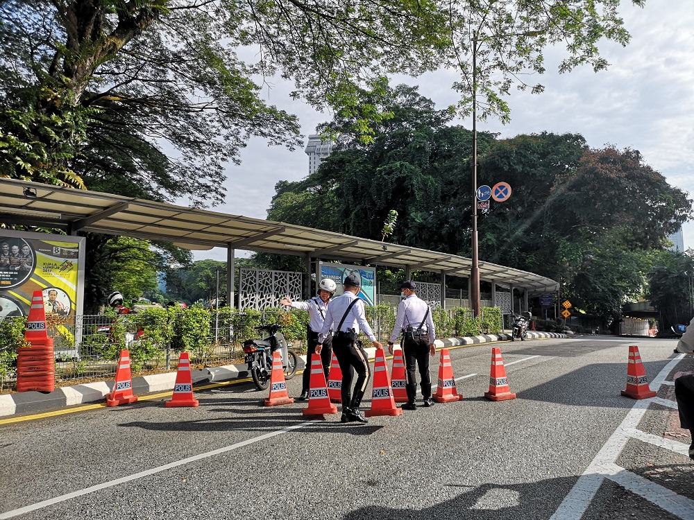 Police personnel set up a road block at the road leading to Dataran Merdeka in Kuala Lumpur July 31, 2021. 