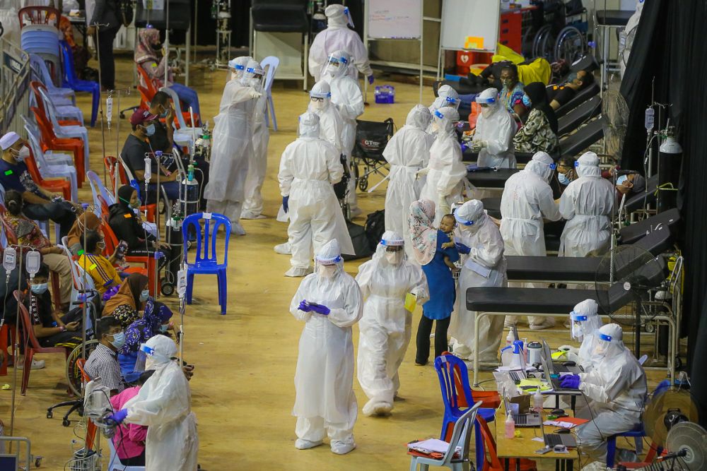 Healthcare workers are pictured at the Covid-19 Assessment Centre at the Malawati Stadium in Shah Alam July 14, 2021. — Picture by Yusof Mat Isa
