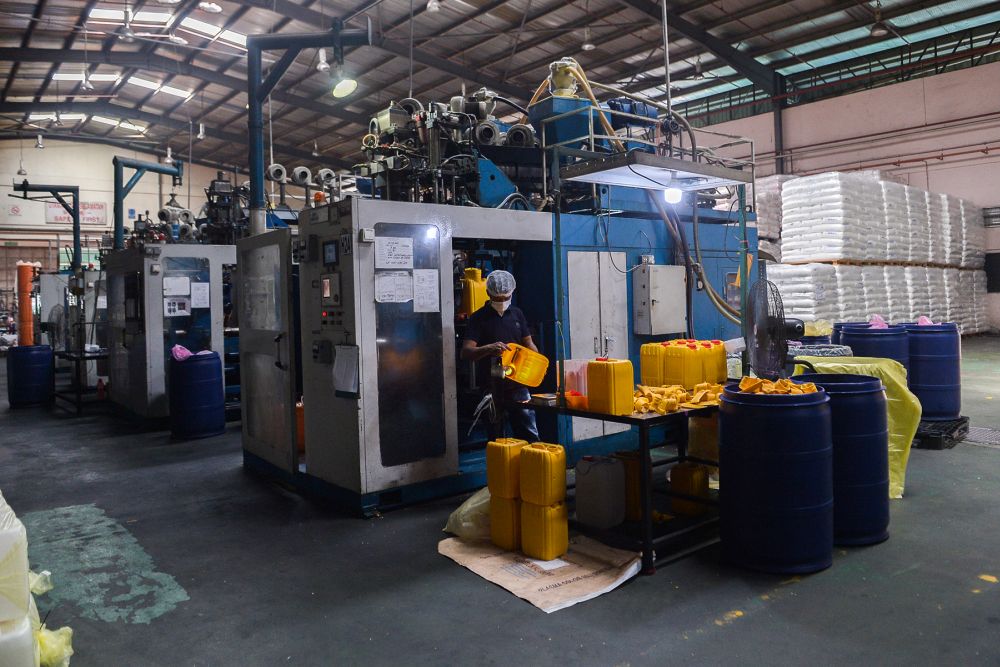A worker is seen at his station at Mapo Industries Sdn Bhdu00e2u20acu2122s plastic container manufacturing plant in Port Klang July 8, 2021. u00e2u20acu201d Picture by Miera Zulyana