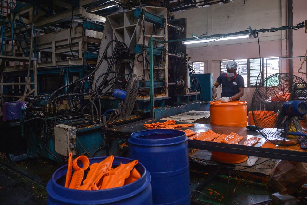 A worker is seen at his station at Mapo Industries Sdn Bhdu00e2u20acu2122s plastic container manufacturing plant in Port Klang July 8, 2021. u00e2u20acu201d Picture by Miera Zulyana