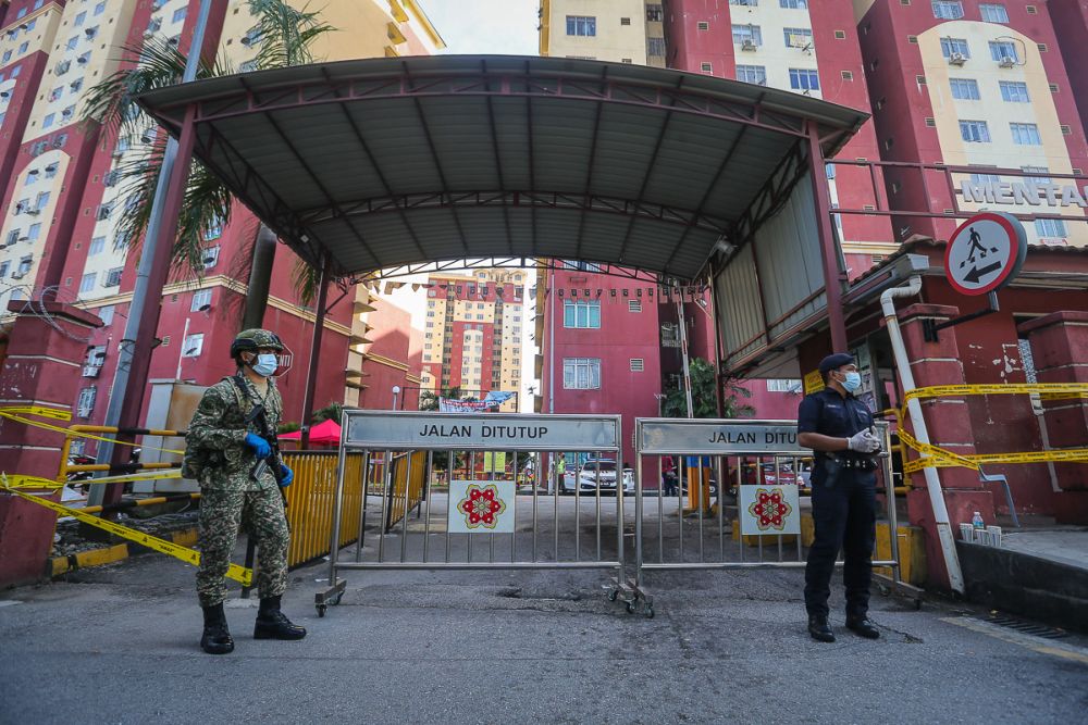 Armed Force and police personnel are pictured at the entrance of Mentari Court in Sunway, which has been placed under the enhanced movement control order July 1, 2021. u00e2u20acu2022 Picture by Yusof Mat Isa