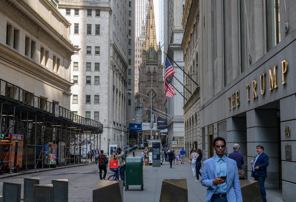 People walk near the New York Stock Exchange (NYSE) at Wall Street on July 15, 2021 in New York City. u00e2u20acu201d AFP pic