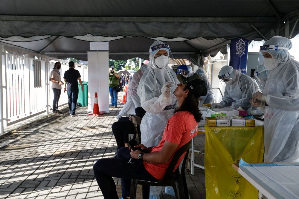 Healthcare workers collect swab samples to test for Covid-19 at the City Stadium in George Town July 5, 2021. u00e2u20acu201d Picture by Sayuti Zainudin