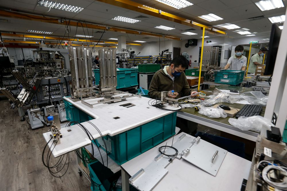 Workers are pictured at their stations at Pentamaster Corporation Bhd in Bayan Lepas July 6, 2021. u00e2u20acu201d Picture by Sayuti Zainudin