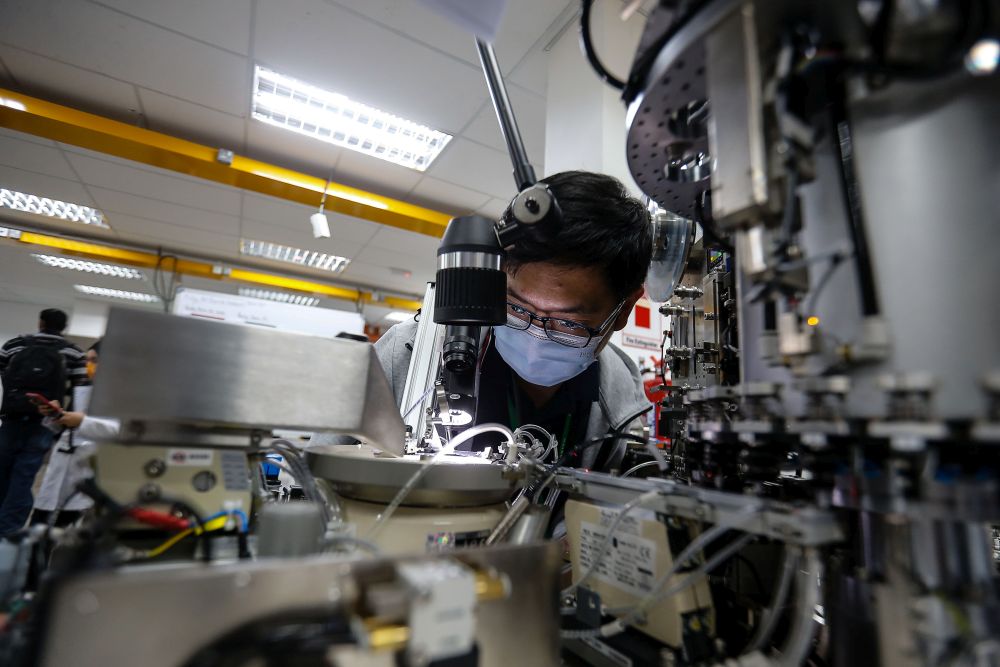 Workers are pictured at their stations at Pentamaster Corporation Bhd in Bayan Lepas July 6, 2021. u00e2u20acu201d Picture by Sayuti Zainudin