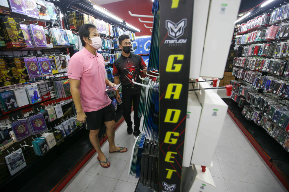 Shamir Sopian, 32, who owns the Manjoy Gadget in Pengkalan, Ipoh reopened his mobile phone accessories shop as the government allowed certain sectors to operate as the state enters Phase Two of the National Recovery Plan. — Picture by Farhan Najib