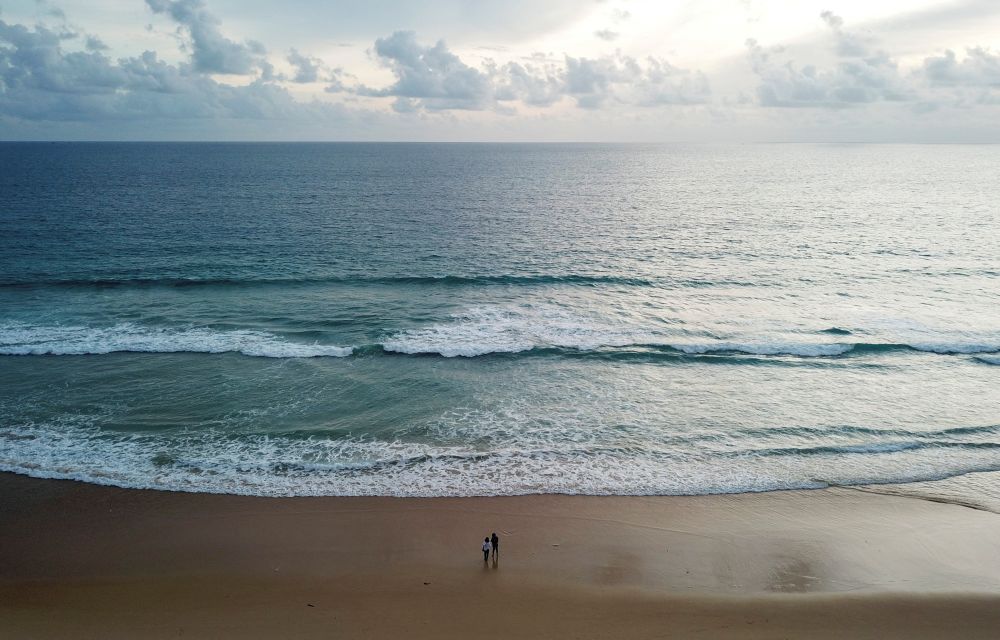 People walk on an empty beach as Phuket gets ready to open to overseas tourists from July 1, 2021. u00e2u20acu2022 Reuters pic