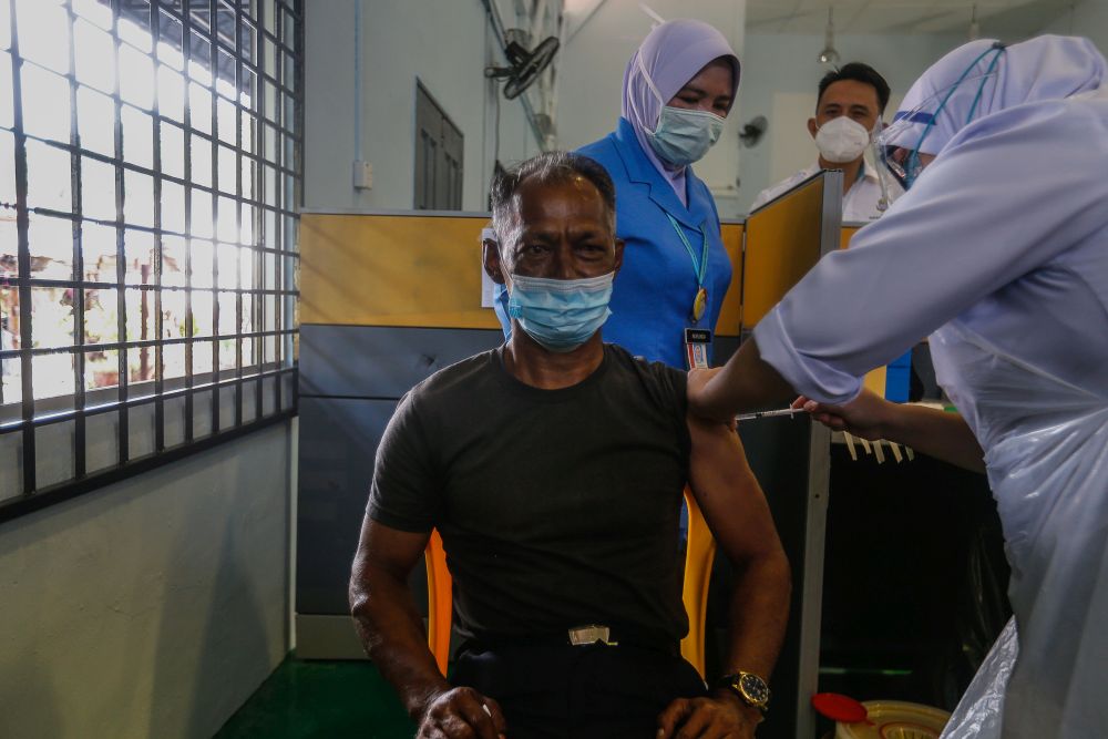 Pulau Aman residents receive their Covid-19 jabs as part of the south Seberang Perai health district's mobile outreach programme in Pulau Aman July 8, 2021. — Picture by Sayuti Zainudin