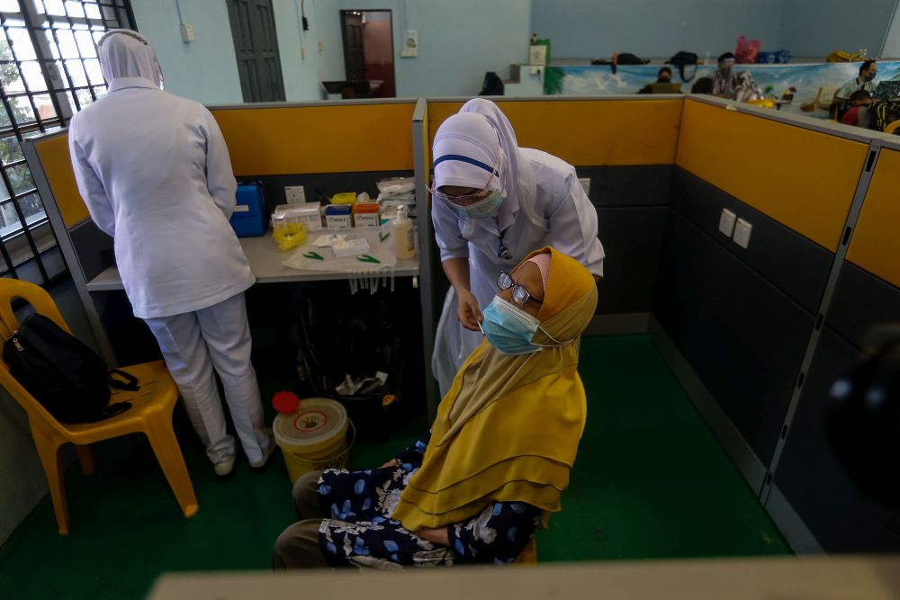 Pulau Aman residents receive their Covid-19 jabs as part of the south Seberang Perai health district's mobile outreach programme in Pulau Aman July 8, 2021. u00e2u20acu201d Picture by Sayuti Zainudin