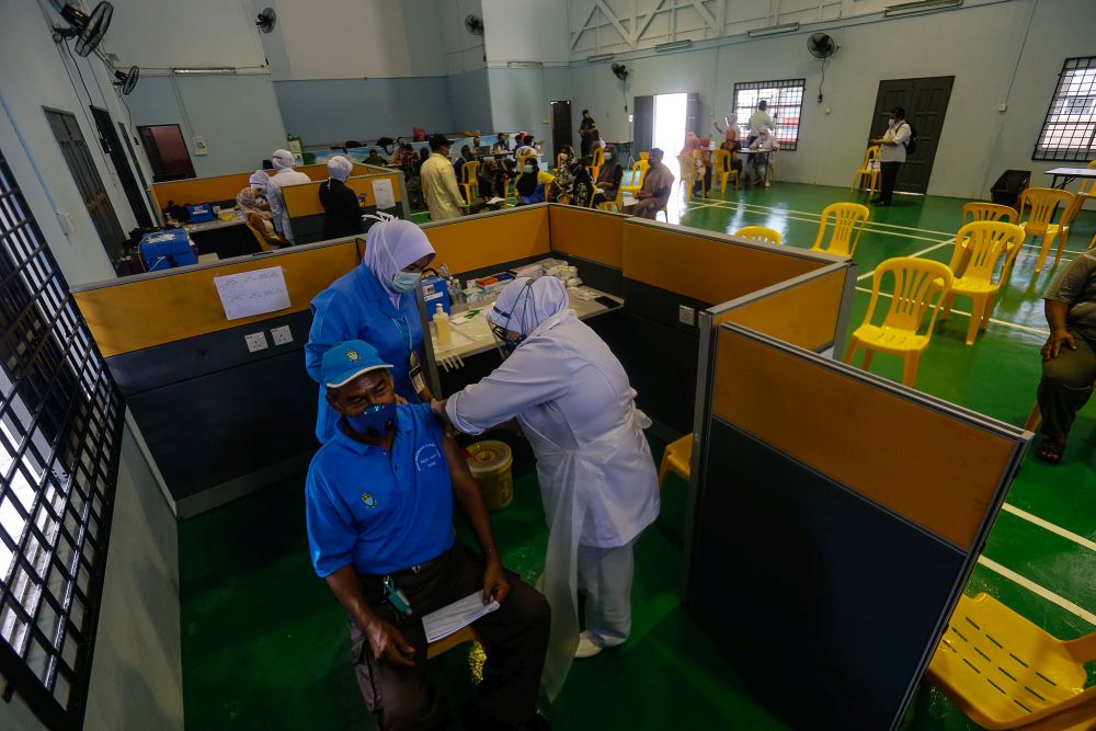 Pulau Aman residents receive their Covid-19 jabs as part of the south Seberang Perai health district's mobile outreach programme in Pulau Aman July 8, 2021. u00e2u20acu201d Picture by Sayuti Zainudin