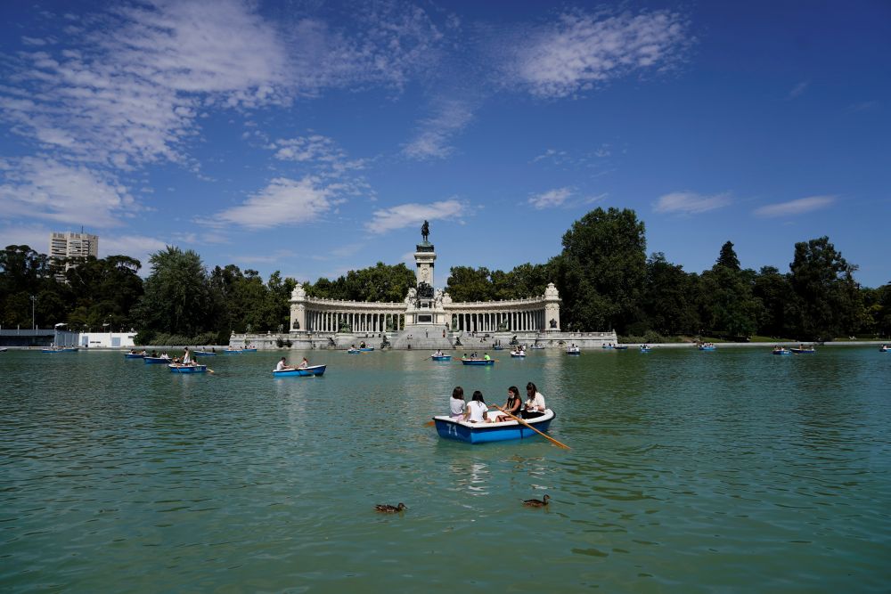 People enjoy boat rides on a lake at El Retiro Park in Madrid July 25, 2021. u00e2u20acu201d Reuters pic