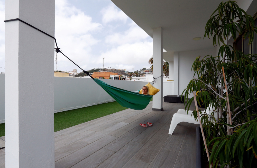 Olga Paul, a 34-year-old from Germany works remotely from Las Palmas De Gran Canaria, relaxes in hammock, amid the coronavirus disease (Covid-19) outbreak, in Gran Canaria, Spain July 23, 2021. u00e2u20acu201d Reuters pic