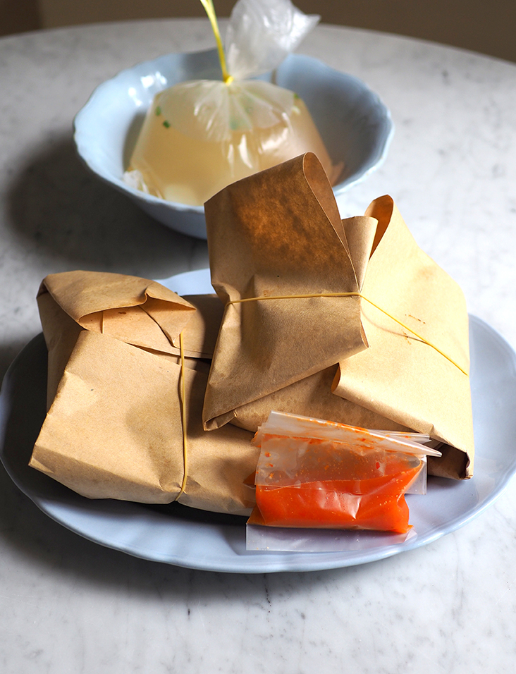 Nostalgic takeaway that is wrapped in a brown paper parcel with soup on the side