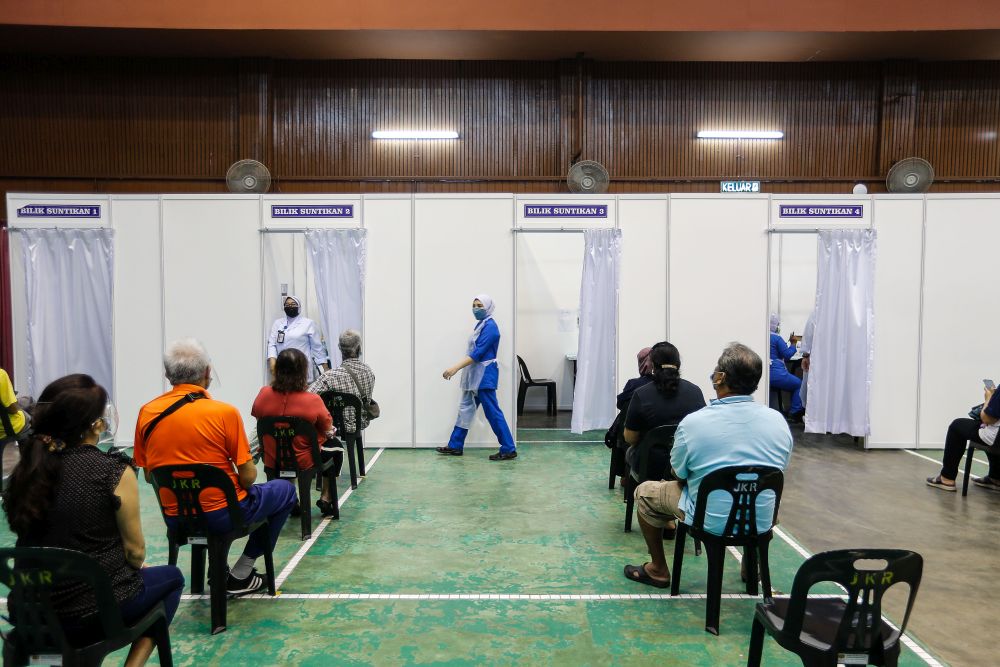 Members of the public wait to receive their Covid jab at the Seberang Jaya Expo Site on July 2, 2021. u00e2u20acu201d Picture by Sayuti Zainudin