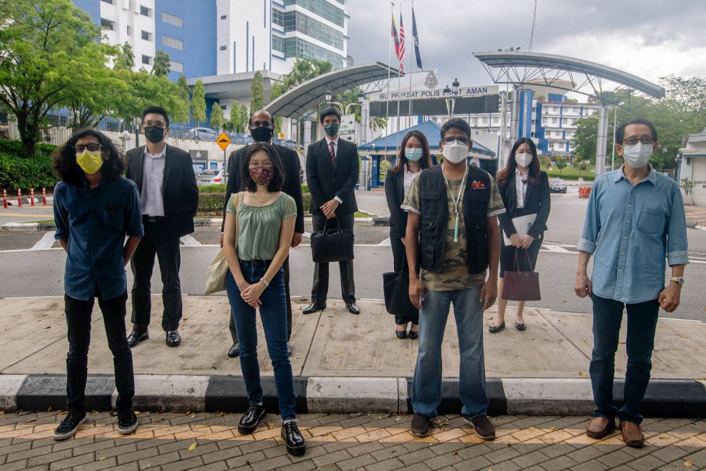 (From left) Mohammad Alshatri, Sharon Wah, Suaram executive director Sevan Doraisamy and Kua Kia Soong are seen with their lawyers at Bukit Aman in Kuala Lumpur July 6, 2021. u00e2u20acu201d Picture by Fidaus Latifnn