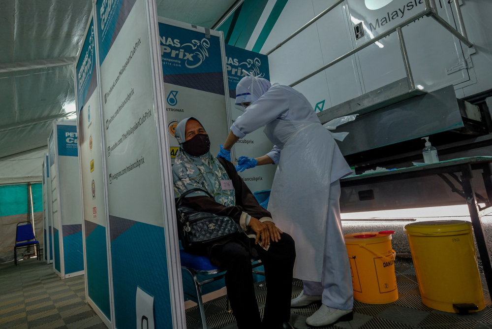 Slim River nurse Siti Munirah Ahmad vaccinates Dalilah Bakar at the Covid-19 Vaccination Outreach Mobile Trailer programme in Perak, July 23, 2021. u00e2u20acu201d Bernama pic 
