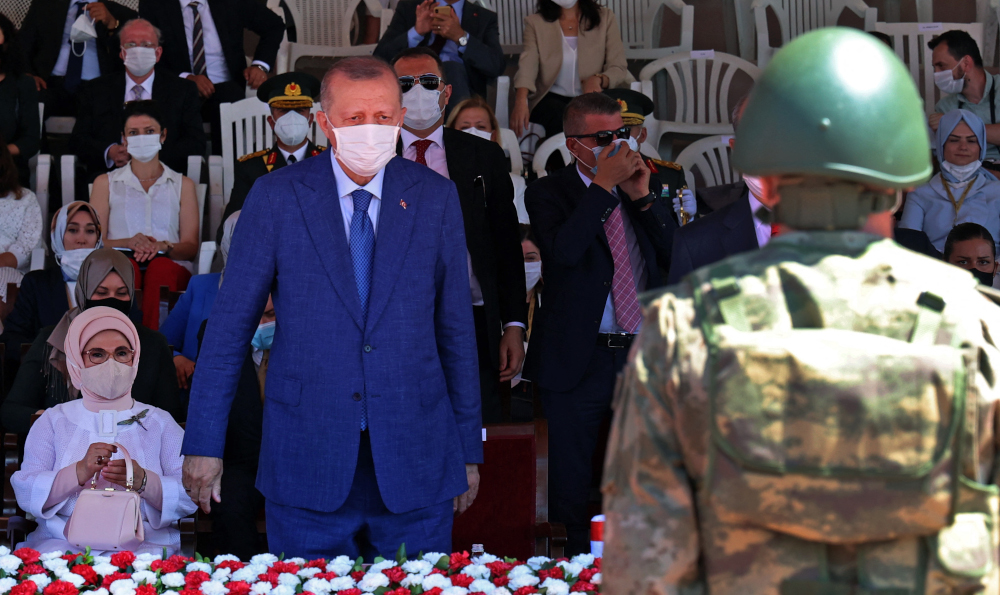 Turkish President Recep Tayyip Erdogan stands next to his wife as they take part in a parade in the northern part of Cyprusu00e2u20acu2122 divided capital Nicosia, in the self-declared Turkish Republic of Northern Cyprus July 20, 2021. u00e2u20acu201d AFP picnn
