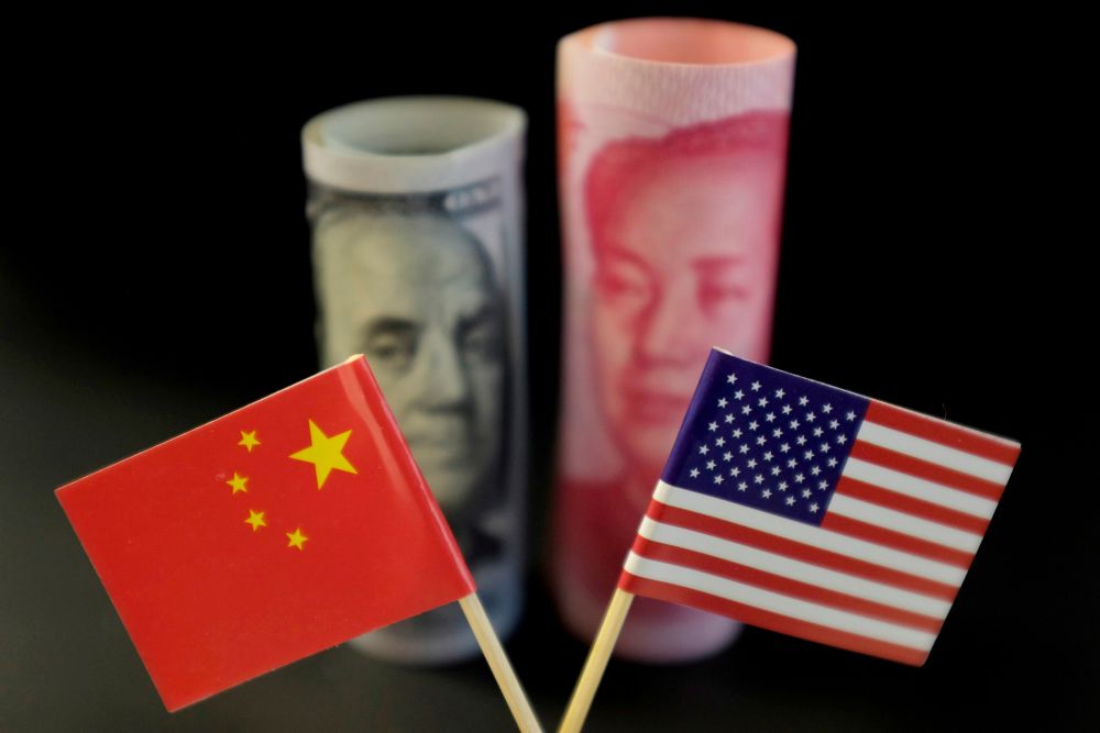 US and Chinese flags are seen in front of a US dollar bank note and a yuan bank note in this illustration picture taken May 20, 2019. u00e2u20acu201d Reuters picnn