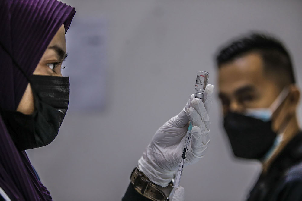 A health worker prepares the Covid-19 vaccination at the vaccination centre (PPV) in Kuala Lumpur Convention Center August 8, 2021. u00e2u20acu2022 Picture by Hari Anggara
