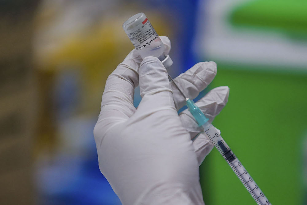 A health worker prepares the Covid-19 vaccination at the vaccination centre (PPV) in Kuala Lumpur Convention Center August 8, 2021. u00e2u20acu2022 Picture by Hari Anggara