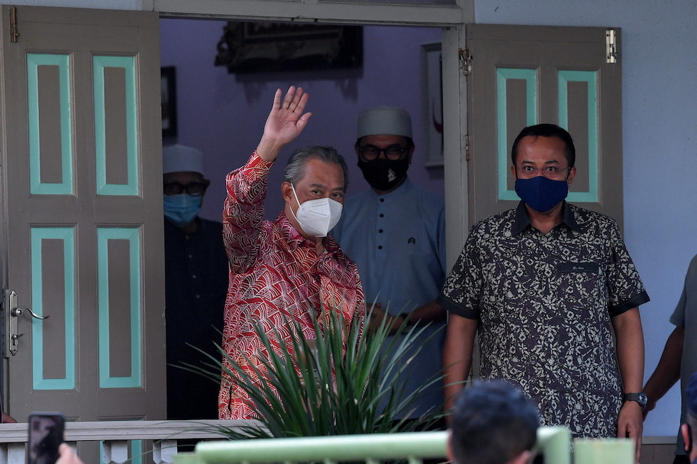 Prime Minister Tan Sri Muhyiddin Yassin waves after his meeting with PAS President Datuk Seri Abdul Hadi Awang at Rusila, in Marang August 12, 2021. u00e2u20acu201d Bernama pic