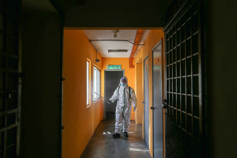 A firefighter sprays disinfectant at Pangsapuri Subang Suria amid the Covid-19 outbreak in Shah Alam August 15, 2021. u00e2u20acu201d Picture by Yusof Mat Isa