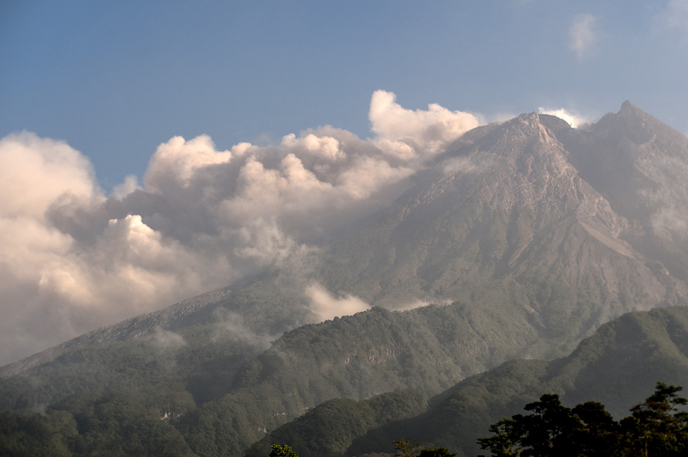 Mount Merapi, Indonesiau00e2u20acu2122s most active volcano, spews ash and smoke 3,500 meters from its peak as seen from Sleman in Yogyakarta August 16, 2021. u00e2u20acu201d AFP pic
