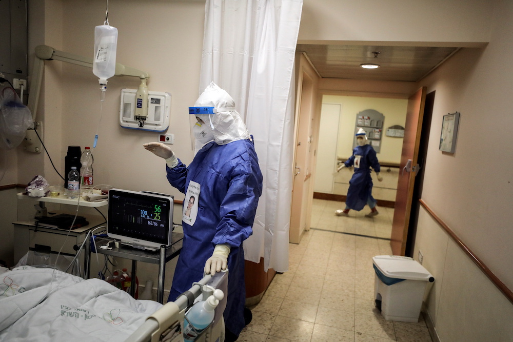 A medical staff member speaks to a patient suffering from Covid-19, in a ward at Beilinson hospital in Petah Tikva, Israel August 18, 2021 u00e2u20acu201d Reuters pic