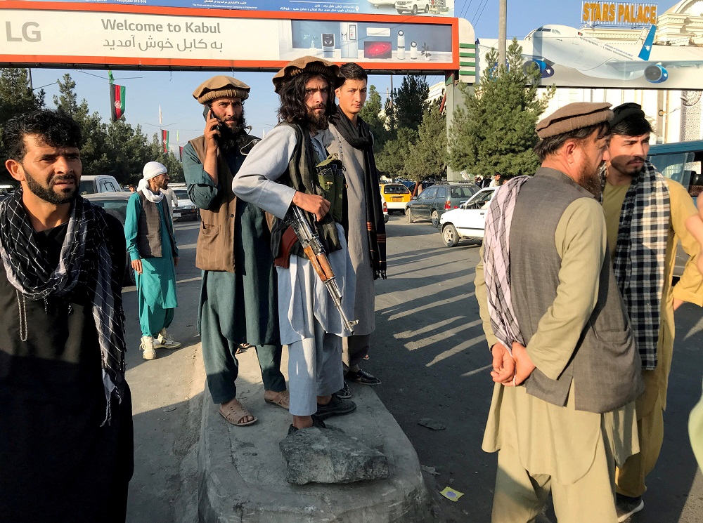 A member of Taliban (centre) stands outside Hamid Karzai International Airport in Kabul, Afghanistan, August 16. u00e2u20acu201d Reuters pic