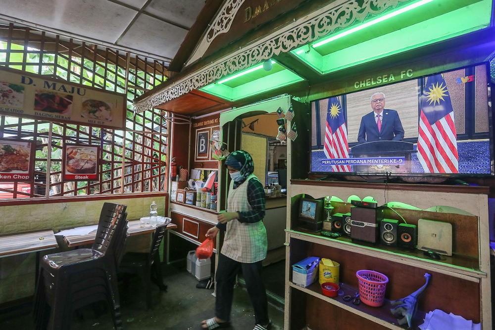 People watch a live telecast of Prime Minister Datuk Seri Ismail Sabri Yaakobu00e2u20acu2122s speech at a restaurant in Kuala Lumpur August 22, 2021. u00e2u20acu201d Picture by Yusof Mat Isa 