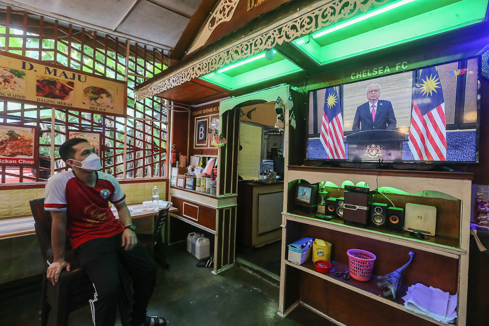 People watch a live telecast of Prime Minister Datuk Seri Ismail Sabri Yaakobu00e2u20acu2122s speech at a restaurant in Kuala Lumpur August 22, 2021. u00e2u20acu201d Picture by Yusof Mat Isa 
