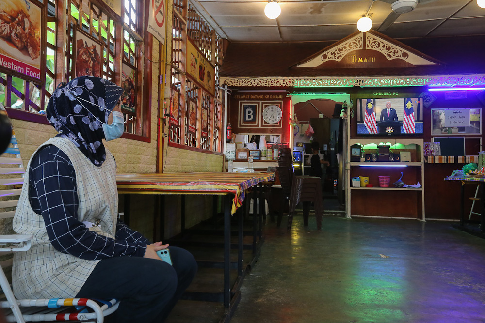 People watch a live telecast of Prime Minister Datuk Seri Ismail Sabri Yaakobu00e2u20acu2122s speech at a restaurant in Kuala Lumpur August 22, 2021. u00e2u20acu201d Picture by Yusof Mat Isa 