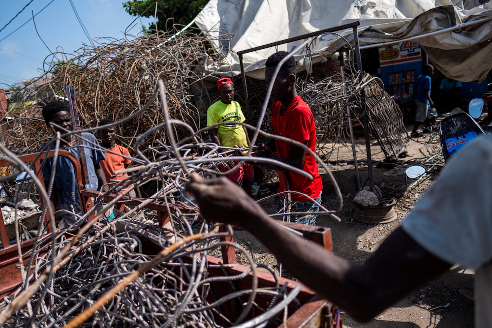 People take metal scavenged from houses destroyed by last week's 7.2 magnitude quake to a recycler in Les Cayes, Haiti August 21, 2021. u00e2u20acu201d Reuters picnn