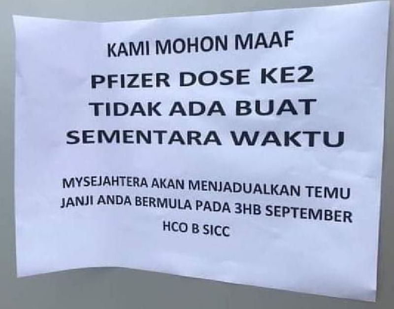 The public notice displayed at the SlCC vaccination centre, informing the public that it has temporarily suspended the second dose of Pfizer vaccination. u00e2u20acu201d Borneo Post pic