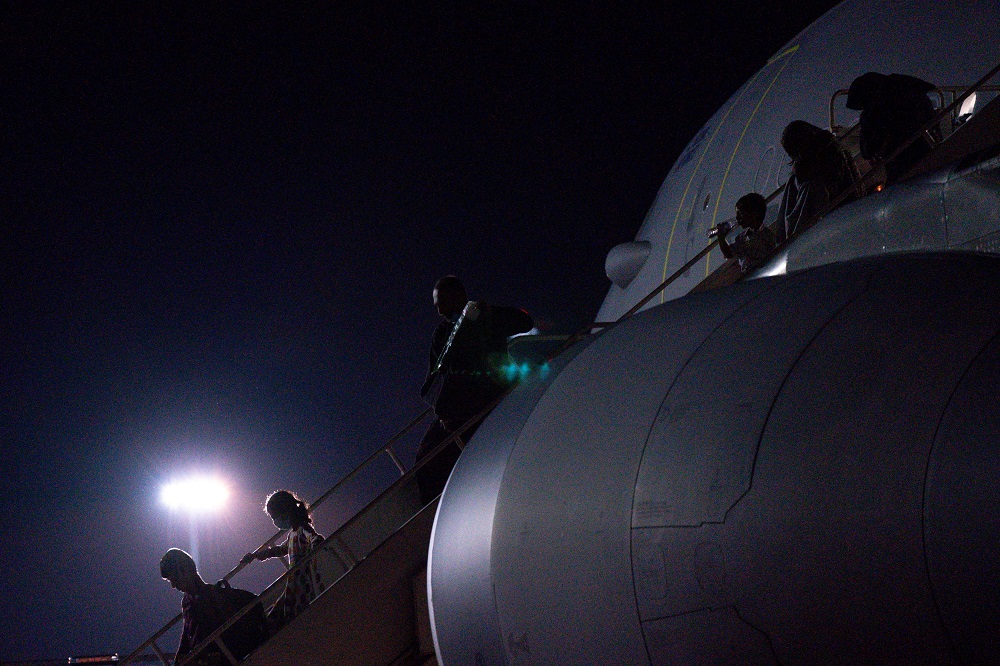 British nationals and Afghan evacuees depart a flight from Afghanistan at RAF Brize Norton, Britain August 26, 2021. u00e2u20acu2022 Jacob King/Pool via Reuters