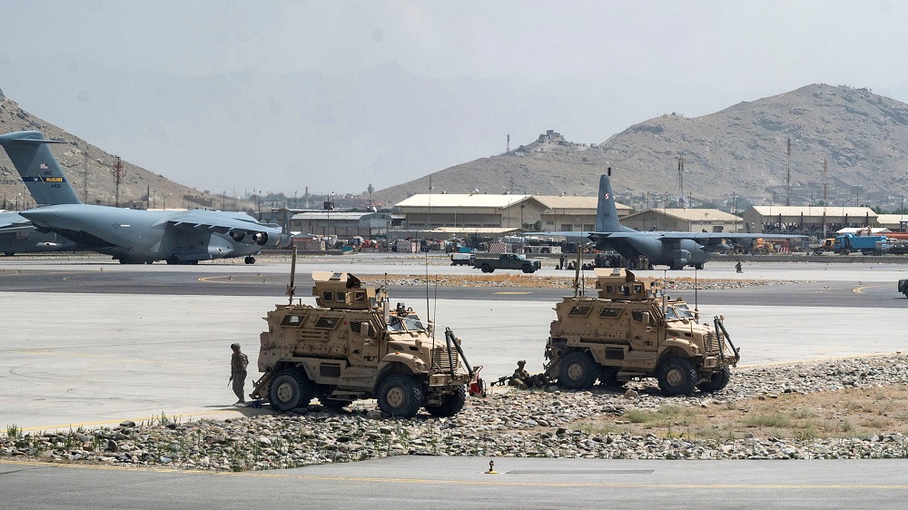US Army soldiers assigned to the 82nd Airborne Division patrol Hamid Karzai International Airport in Kabul, Afghanistan August 17, 2021. u00e2u20acu2022 US Air Force/Senior Airman Taylor Crul/Handout via Reuters