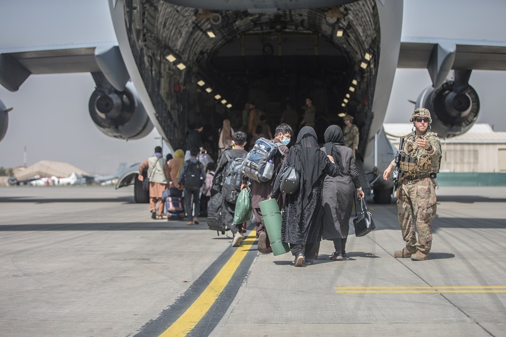 Families begin to board a US Air Force C-17 Globemaster III transport plane during an evacuation at Hamid Karzai International Airport, Afghanistan August 23, 2021. u00e2u20acu2022 US Marine Corps/Sgt. Samuel Ruiz/Handout via Reuters