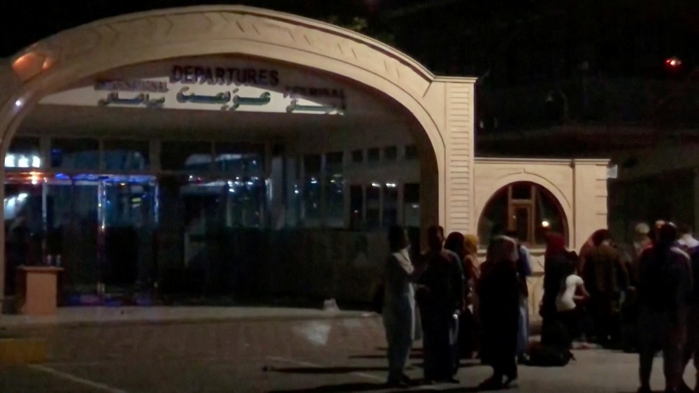People stand outside the departure building at Kabul airport, Afghanistan August 23, 2021, in this still image taken from video. Video taken August 23, 2021. u00e2u20acu2022 Reuters pic
